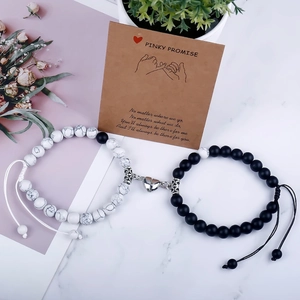 Detail of magnetic heart couple bracelets with matte black stone and white turquoise