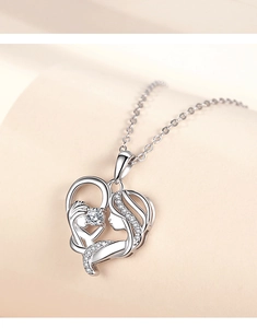 Macro shot of S925 sterling silver heart pendant featuring mother and child silhouette with gems