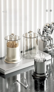Detail of clear acrylic storage jars with diamond-cut lids and elegant silver tray