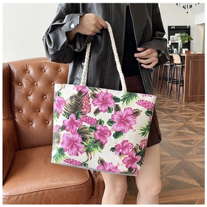 Close-up of tropical floral tote bag with sturdy white rope handles and canvas texture