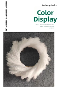 Detailed close-up of a fluffy white faux reed Christmas wreath on a grey felt background