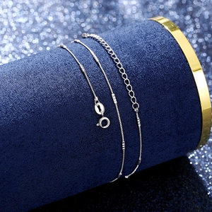 Detailed macro view of a silver box chain with a round spring clasp and extender