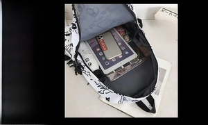Spacious interior of white graffiti backpack showing storage for iPad and daily essentials