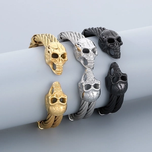 Detailed view of punk skull wire bracelets in gold, silver, and black finishes