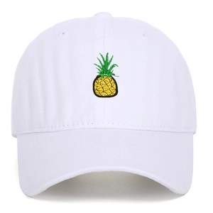 Close-up of white washed cotton baseball cap with detailed pineapple embroidery on front