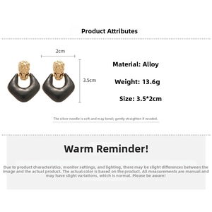 Detail view of 3.5cm x 2cm rhombus drop earrings with hammered texture and black finish