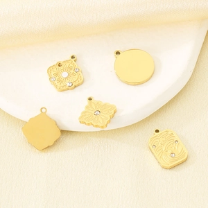 Macro detail of French vintage irregular gold pendants with micro-inlaid diamonds and patterns