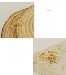 Detail of adjustable gold stainless steel ring featuring marquise-cut zircon stones