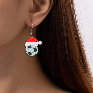 Close-up of festive soccer ball earring with a Santa hat worn by a female model