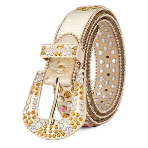 Close-up of gold leather belt with luxury rhinestones, metal studs, and crystal buckle