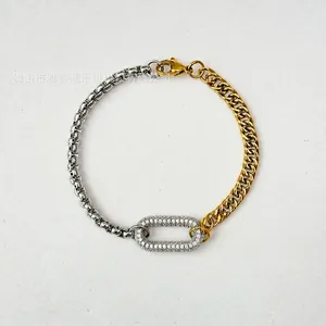 Macro detail of two-tone chain bracelet with micro-paved cubic zirconia buckle