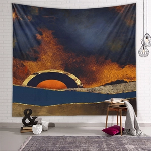 Detailed view of an abstract sunset tapestry hanging on a white brick wall in a cozy room