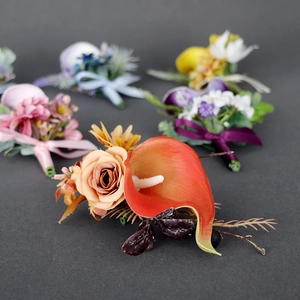 Orange calla lily and rose boutonniere with berries for wedding suits and formal attire