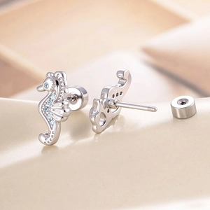 Silver seahorse stud earrings with micro-set blue zircons for cartilage piercing