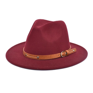 Detailed view of wine red fedora hat with brown leather band and metallic buckle