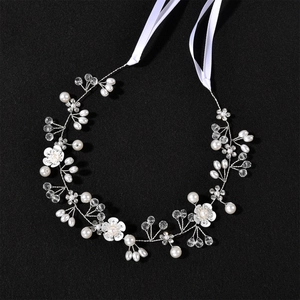 Elegant white floral bridal headband with pearls, crystals and ribbon for weddings