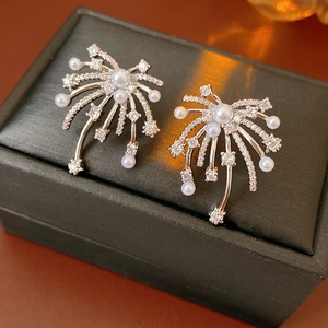 Detail of silver pearl earrings with zircon fireworks design on black leather box