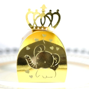 Close-up of golden elephant hollow candy box with heart patterns and crown handle
