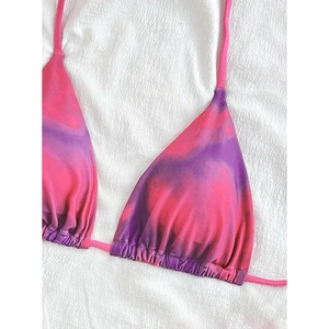 Detail of pink and purple tie-dye bikini top with triangle cups and drawstring texture