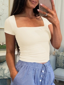 Close-up of a white square neck slim fit short sleeve top on a model in a mirror selfie