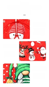 Close-up of red plush Christmas tree skirt with festive Santa and reindeer patterns