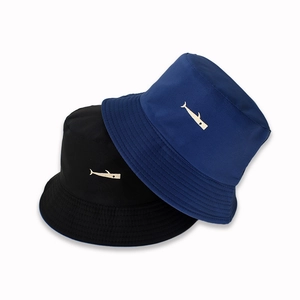 Detail of cute whale embroidery on black and navy reversible cotton sun hats