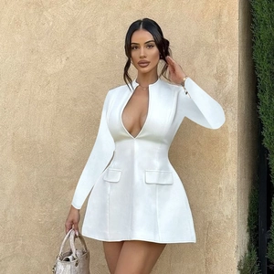 Detail of white V-neck mini dress showing long sleeves and decorative waist pockets