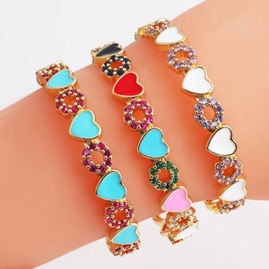 Detailed macro view of colorful heart enamel bracelets with sparkling zircon accents
