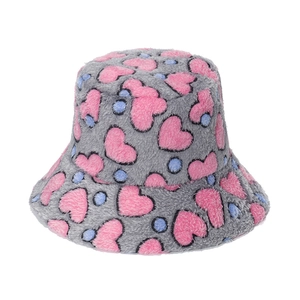 Close-up of grey plush bucket hat with pink heart patterns and soft faux fur texture