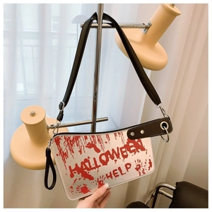 Detail of cleaver-shaped crossbody bag with red splatter and Halloween text print