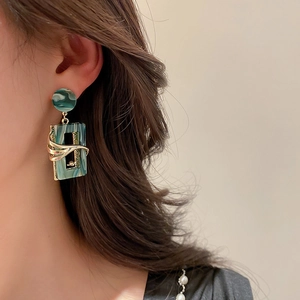 Vintage green acrylic geometric earrings with marble texture and gold metal frame on model