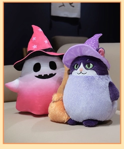 Detail of plush Halloween ghost and cat dolls with wizard hats on a cozy beige sofa