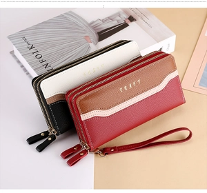 Detailed macro view of the double zipper compartments and litchi grain faux leather texture