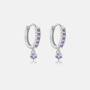 Macro shot of S925 sterling silver hoop earrings with dangling purple star stones