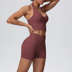 Detailed side view of high-waist yoga shorts and halter sports bra in deep mauve