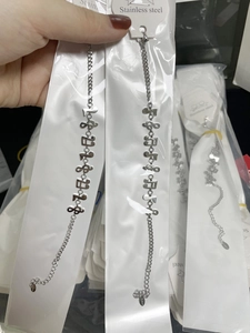 Macro view of silver musical note bracelet in stainless steel packaging