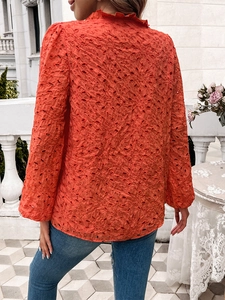 Detail of orange hollow embroidery top with puff sleeves and ruffled collar back view