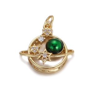 Macro shot of gold planet pendant with green bead and sparkling crystal stars