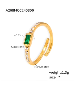 Detail view of gold titanium ring with green square stone, showing 1.3g weight and 0.33cm size