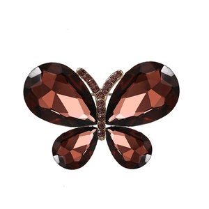 Elegant butterfly brooch with faceted amber crystals and purple gems on gold metal