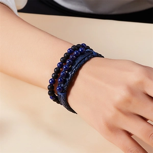 Men's layered bracelet set featuring blue braided leather and matte black bead strands
