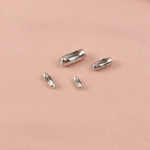 Four silver stainless steel bead chain connectors for DIY jewelry making on pink fabric