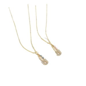 Chic gold safety pin necklaces with evil eye charms and sparkling rhinestones