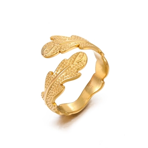 Adjustable golden stainless steel ring featuring a detailed leaf design on white background
