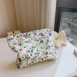 Detailed view of floral cotton makeup bag with blue and purple prints and top zipper