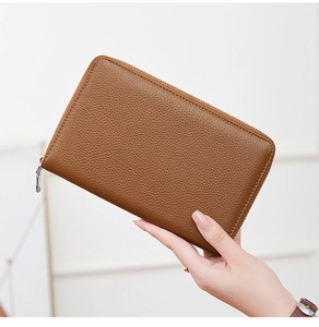 Detail of genuine brown leather wallet showing textured finish and wraparound zipper