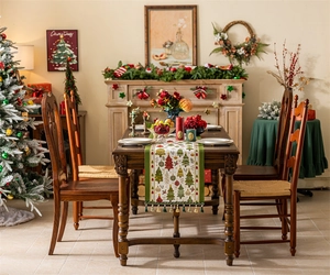 Detail of Christmas table runner with green tassels and festive tree jacquard patterns