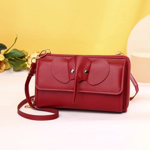 Detailed close-up of dark red elephant crossbody phone bag with metal zipper and leather texture