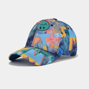 Detail of street fashion baseball cap featuring tie-dye galaxy print and graffiti letters