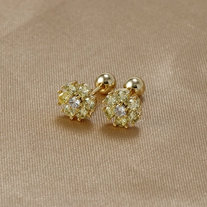 Close-up of gold floral earrings with yellow cubic zirconia and screw back closures